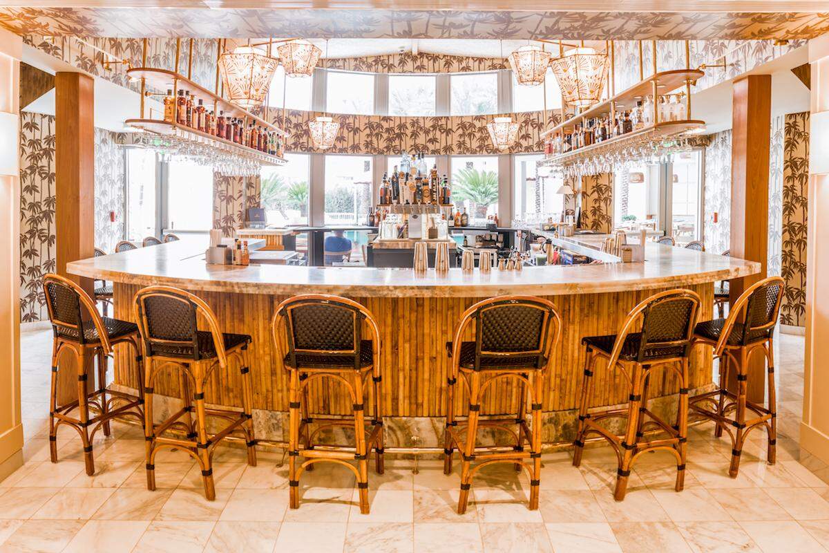 The lobby bar at The Plymouth features bamboo wood for an indoor tiki aesthetic.