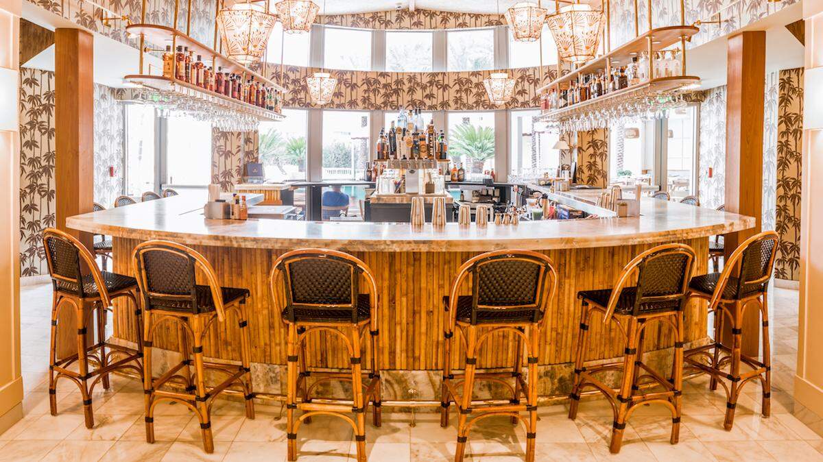 The lobby bar at The Plymouth features bamboo wood for an indoor tiki aesthetic.