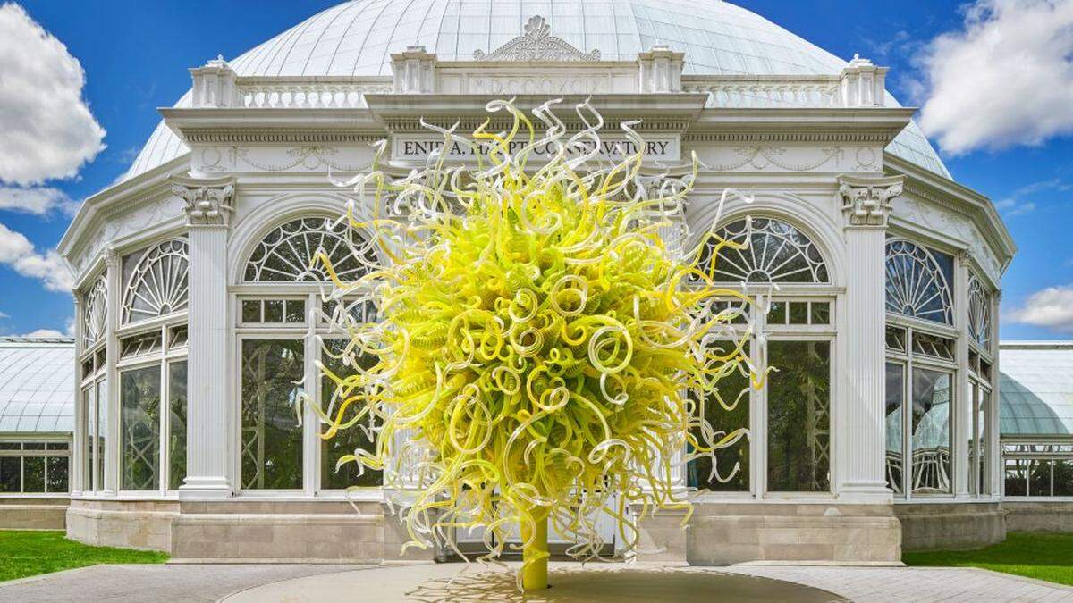 Chihuly's Sol de Citron at the foot of New York Botanical Garden's Haupt Conservatory.