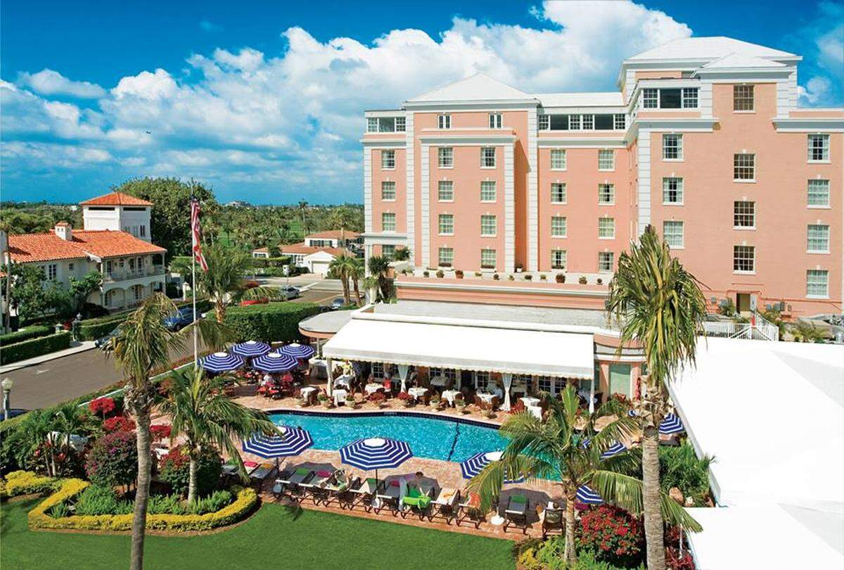 This pink stucco beauty also has a pool shaped like the state of Florida.