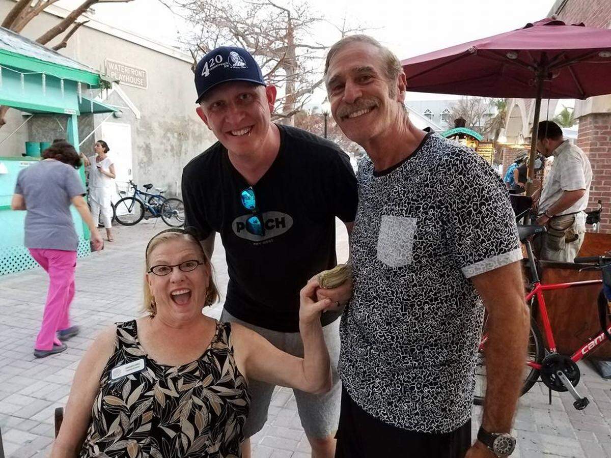 Christopher Shultz (center) at the Key West Mallory Square Reclamation celebration with locals Ginger King and George Fernandez. Photo courtesy The Weekly Newspapers.