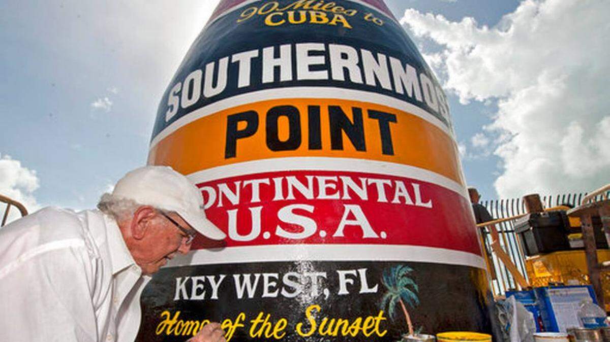 Artist Danny Acosta completes lettering the Southernmost Point in the Continental U.S.A. marker in Key West.