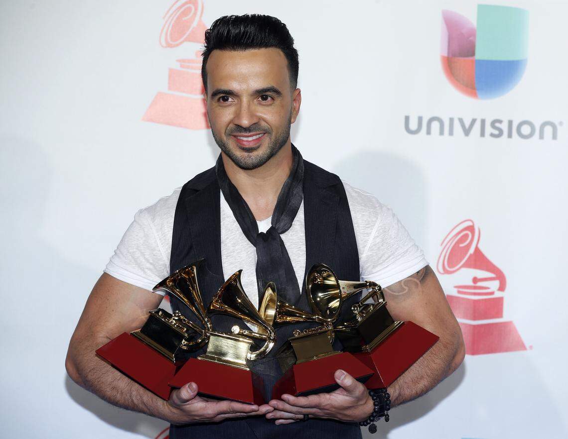 Luis Fonsi poses with the awards for Best Urban/Fusion/Performance, Best Short Form Music Video, Record of the Year, and Song of the Year for "Despacito" at the 18th annual Latin Grammy Awards at the MGM Grand Garden Arena on Thursday, Nov. 16, 2017, in Las Vegas. (Photo by Eric Jamison/Invision/AP)