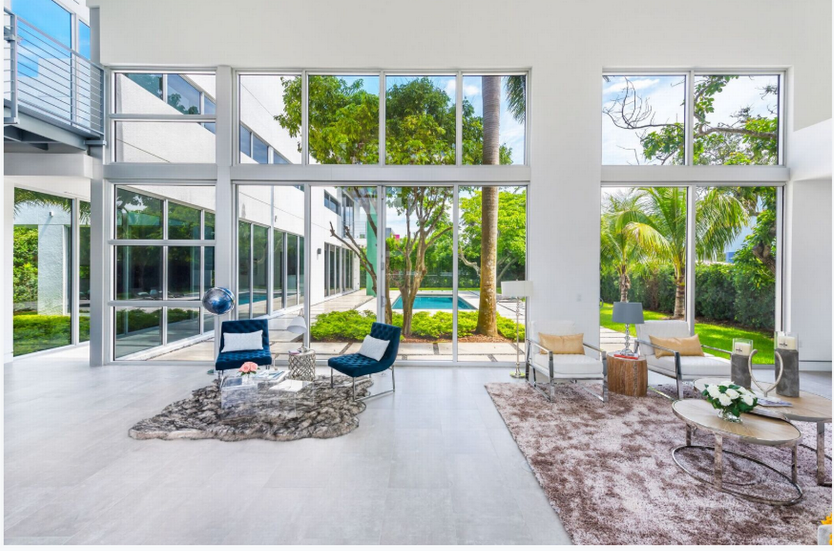 The living room of the house in Pinecrest that overlooks the backyard with pool.