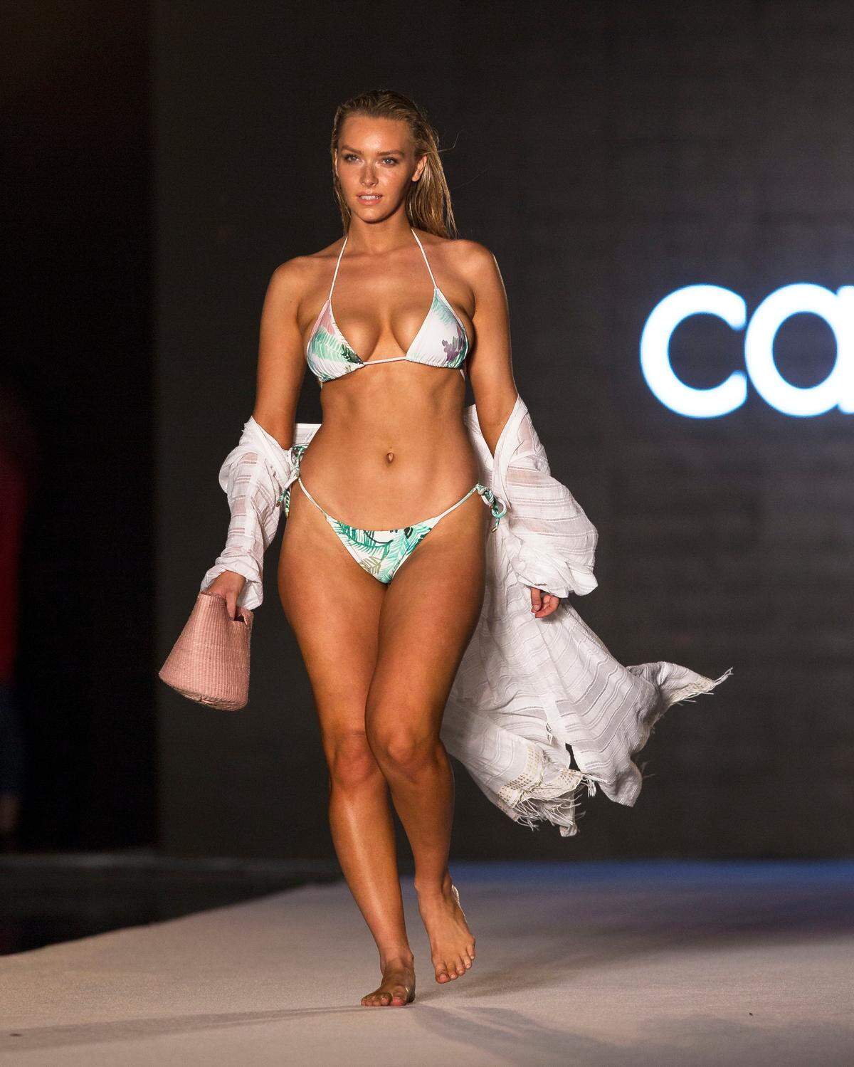 A model walks the runway for the 2018 Sports Illustrated Swimsuit show at PARAISO during Miami Swim Week at The W Hotel South Beach in Miami Beach, FL, on July 15, 2018.