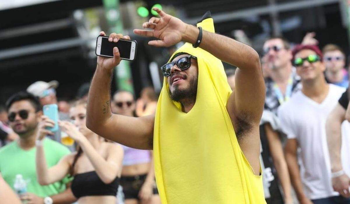 Jose Enrique Mendieta, 20, from Miami, wears his banana suit while dancing during the first day of the Ultra Music Festival in Bayfront Park on Friday, March 24, 2017.