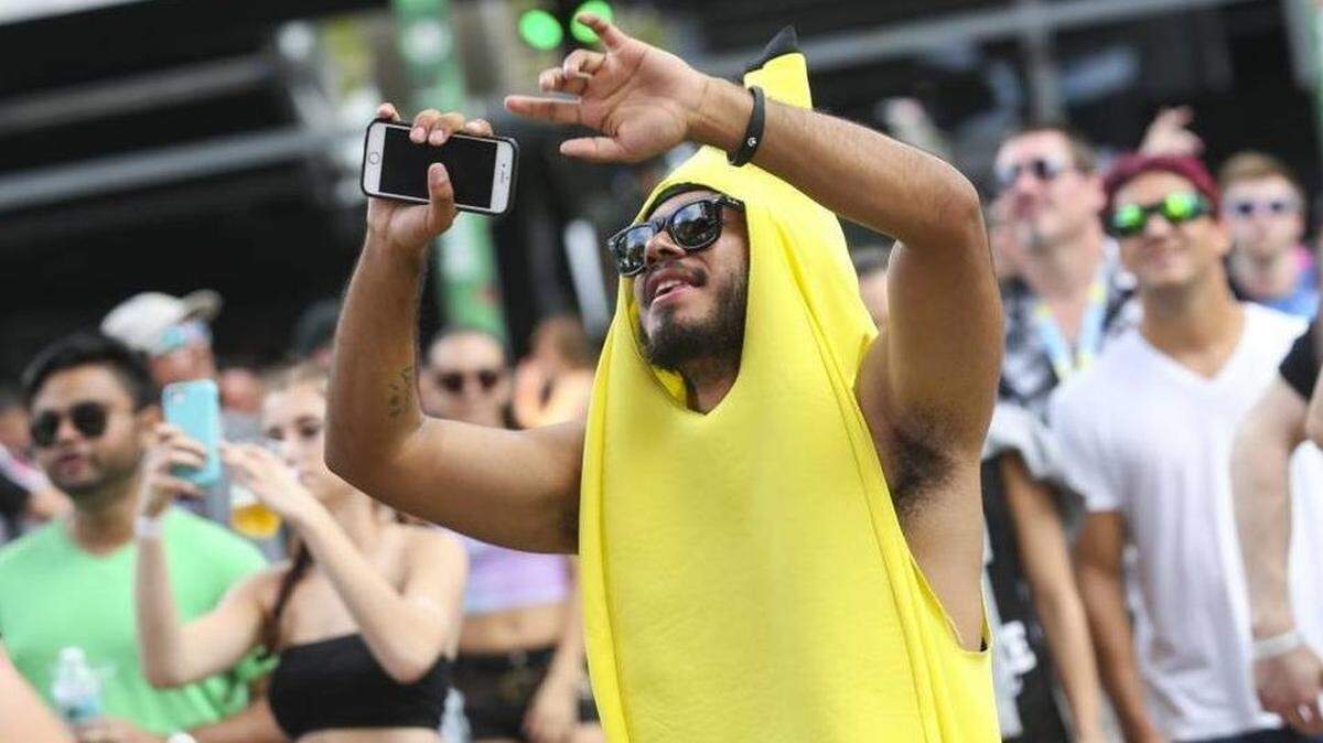 Jose Enrique Mendieta, 20, from Miami, wears his banana suit while dancing during the first day of the Ultra Music Festival in Bayfront Park on Friday, March 24, 2017.