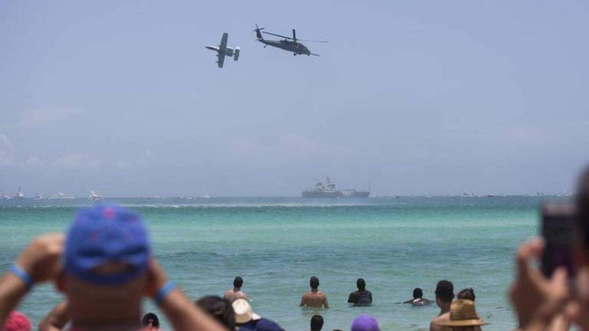 United States Air Force helicopters and planes fly over beachgoers during Memorial Day Weekend 2017. MATIAS J. OCNER For the Miami Herald
