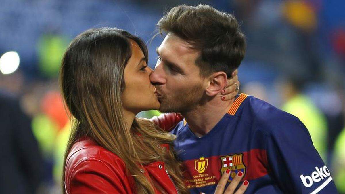 FILE - This is a Sunday, May 22, 2016  file photo of Barcelona's Lionel Messi, kisses his girlfriend Antonella Roccuzzo as they celebrate after winning the final of the Copa del Rey soccer match between FC Barcelona and Sevilla FC at the Vicente Calderon stadium in Madrid. Messi who will be the center of the attentions on Friday June 30, 2017  in his hometown of Rosario, Argentina,where he will be marrying 29-year-old Antonella Roccuzzo, his childhood friend and mother of his two children. (AP Photo/Francisco Seco/ File)