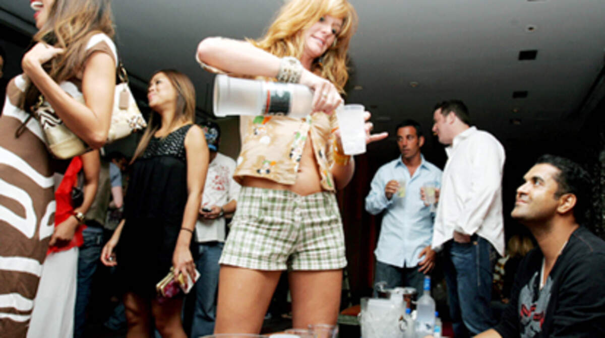 <p> Samantha Bearden pours some drinks for friends after club promoter Hassan Radouane orders through a full bottle service at Club Shore in Miami Beach Sunday night. Full bottle services have been popular at the Shore Club for the past 6 years. Photo: Cheryl A. Guerrero</p>