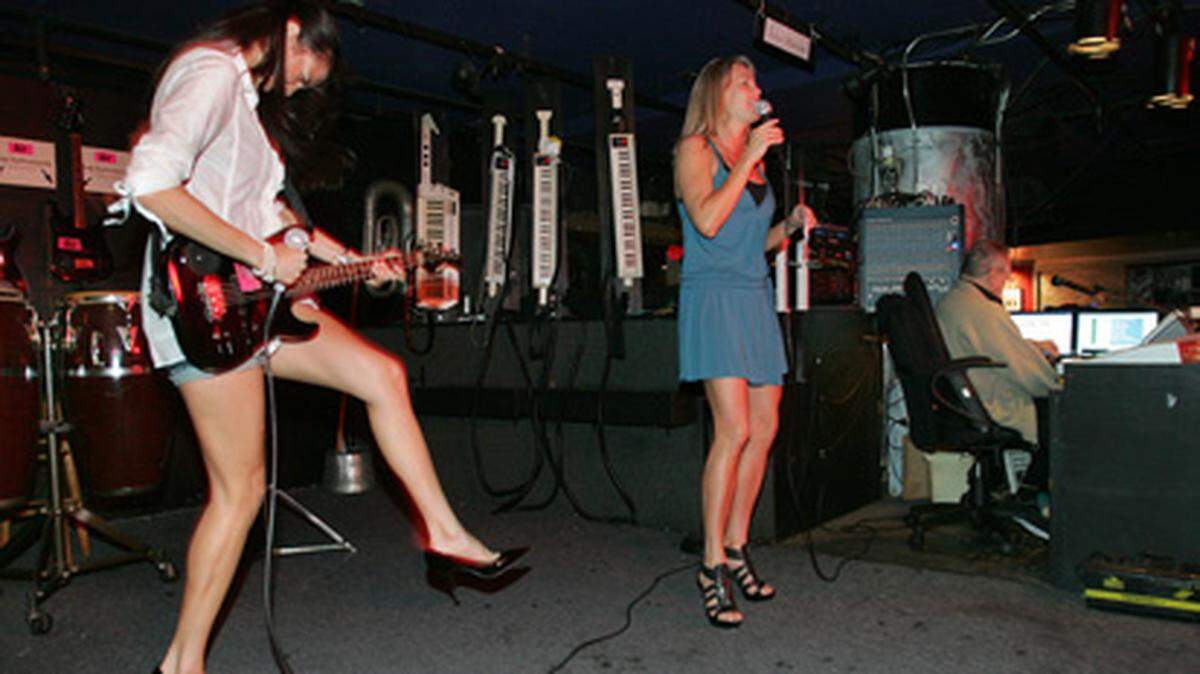 Jessica Bostwick plays the guitar while Karen McCarthy sings karaoke at Studio inside the Shelbourne Hotel in Miami Beach. Studio features 55,000 for karaoke as well as various instruments for participants to play along with. Photo: Nissa Benjamin.