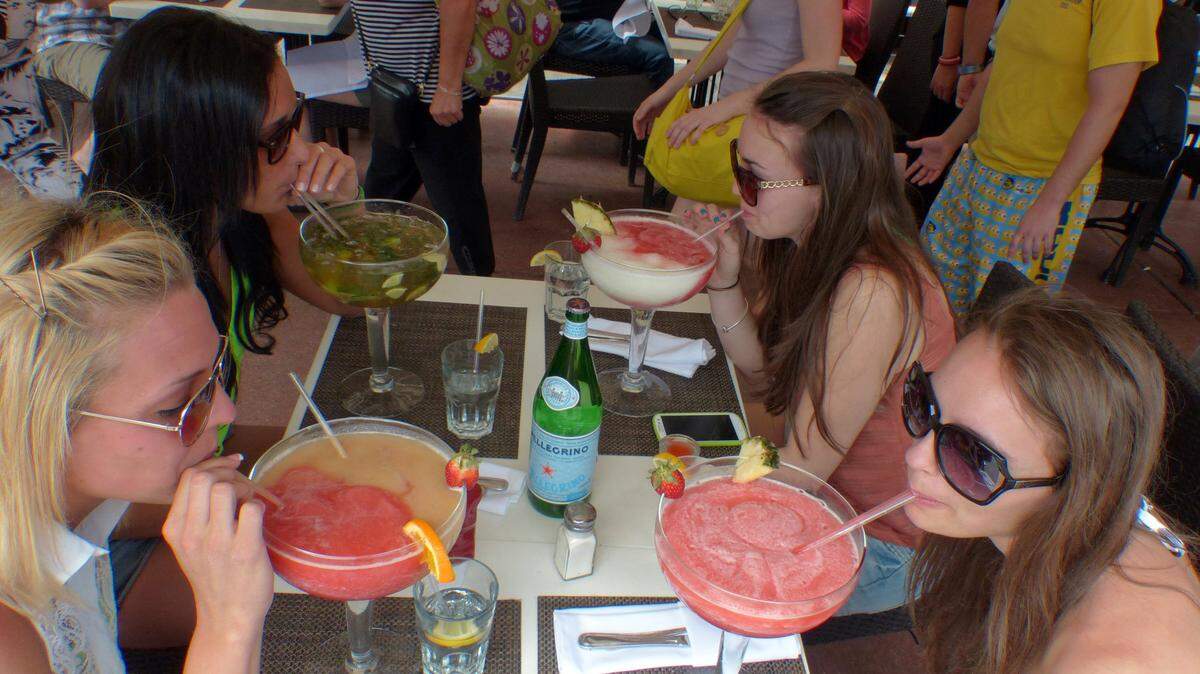 Megan Cockroft, (lower left then clockwise) Jordyn Fisher,. Kaitlyn Galati, and Alli Boettinger, all from Montclair State University just arrived from New Jersey for Spring Break. They are enjoying some large drinks along Ocean Drive on South Beach. (Walter Michot)