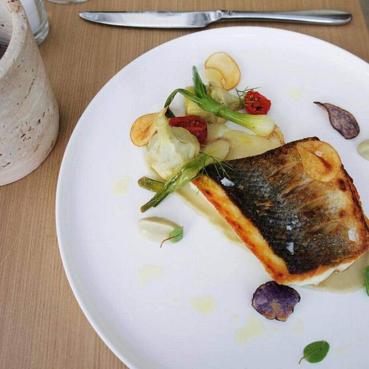 A golden, skin-on branzino filet over a delicate artichoke puree with crispy fried fingerling potatoes is a study in simplicity at Forte dei Marmi.