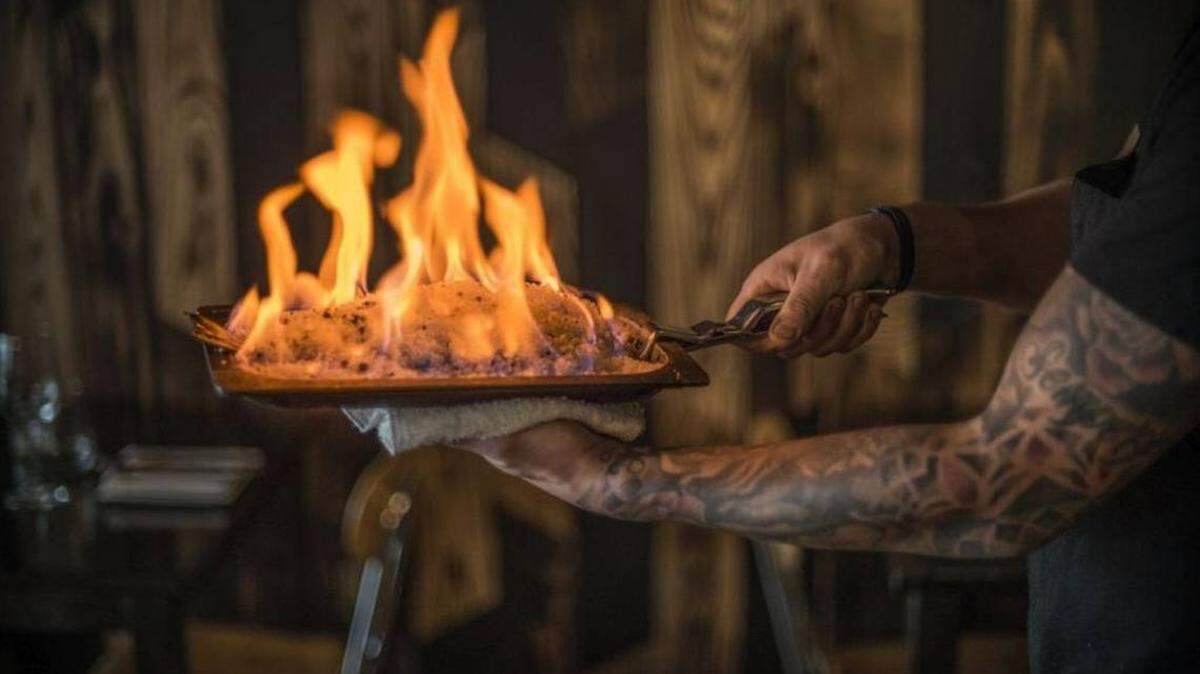 The salt-crusted dorada arrives tableside aflame in Pernod, imbuing the fish with its anise scent. Felipe Cuevas for INDULGE magazine