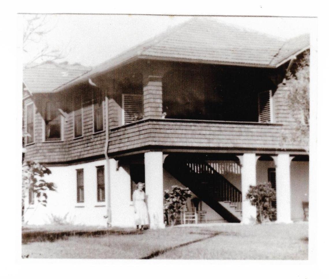 What is believed to be Florence Haden posing by her original wooden home in Coconut Grove, where she and her husband, John, discovered the Haden mango. This photo was handed down from the developer who knocked down the original house to build a new one, now owned by television journalist Antonio Mora.