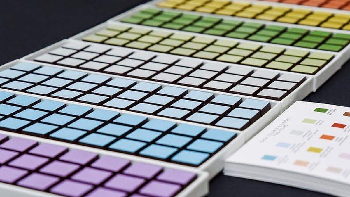 Bon Chocolatier's chocolate gift sets are displayed in a rainbow of hues, like a watercolor set.