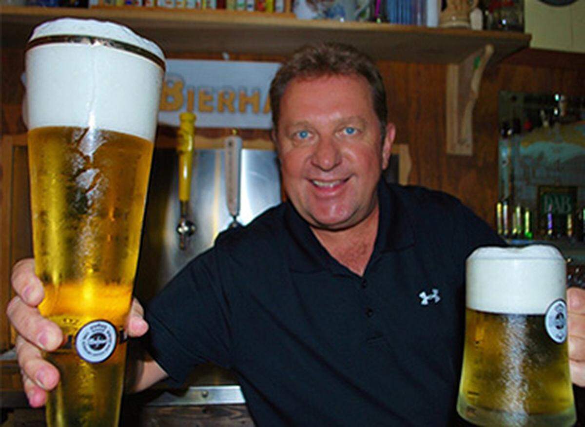 Neuweg proudly holding up Warsteiner drafts at his Fritz &amp; Franz Bierhaus in Coral Gables. (Handout)