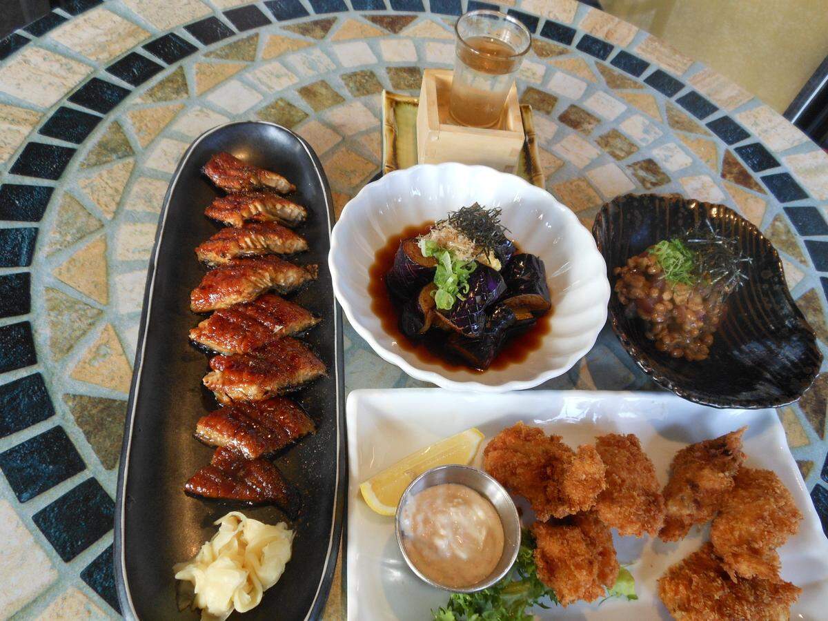 Grilled eel, deep-fried eggplant, tuna, fried oysters and sake at Yakko-San in North Miami Beach.