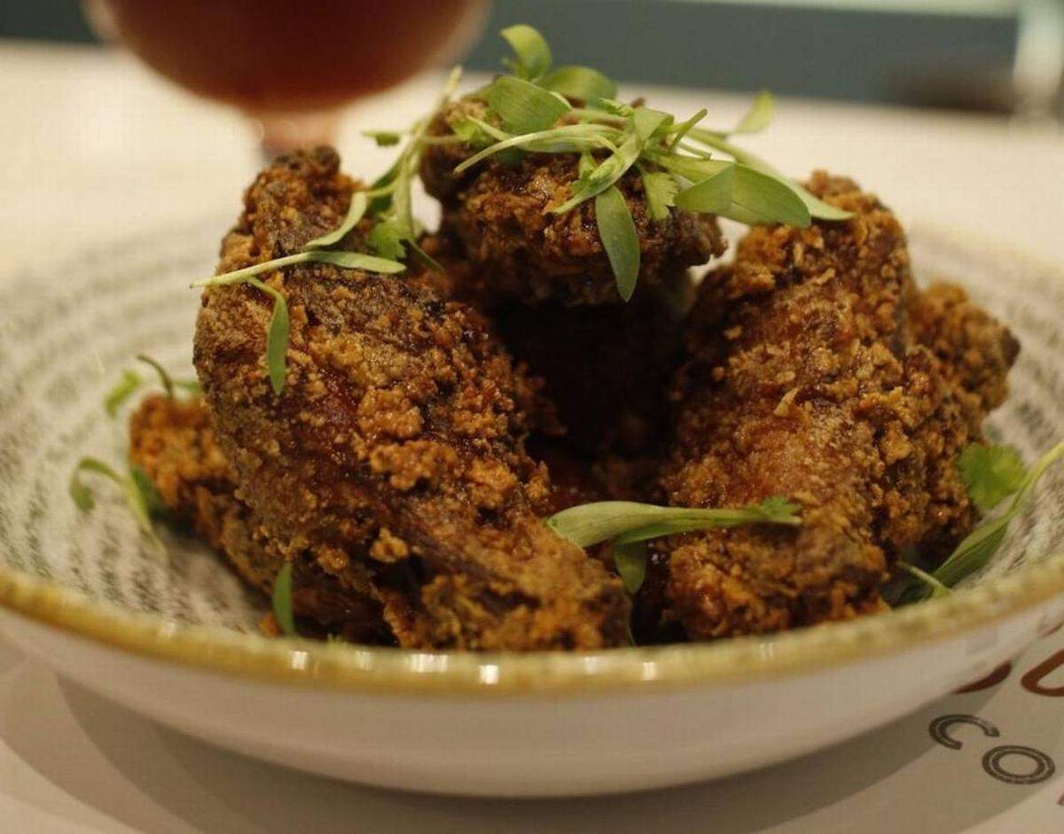 Vietnamese Fish Sauce Wings are among the fusion dishes at the new Amelia 1931 Cuban diner in west Kendall.