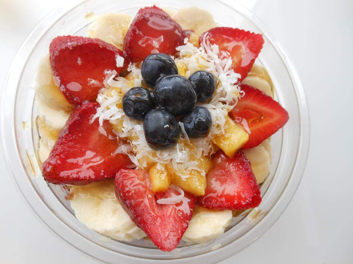 Acai bowl with granola, bananas, berries and shredded coconut at Carrot Express