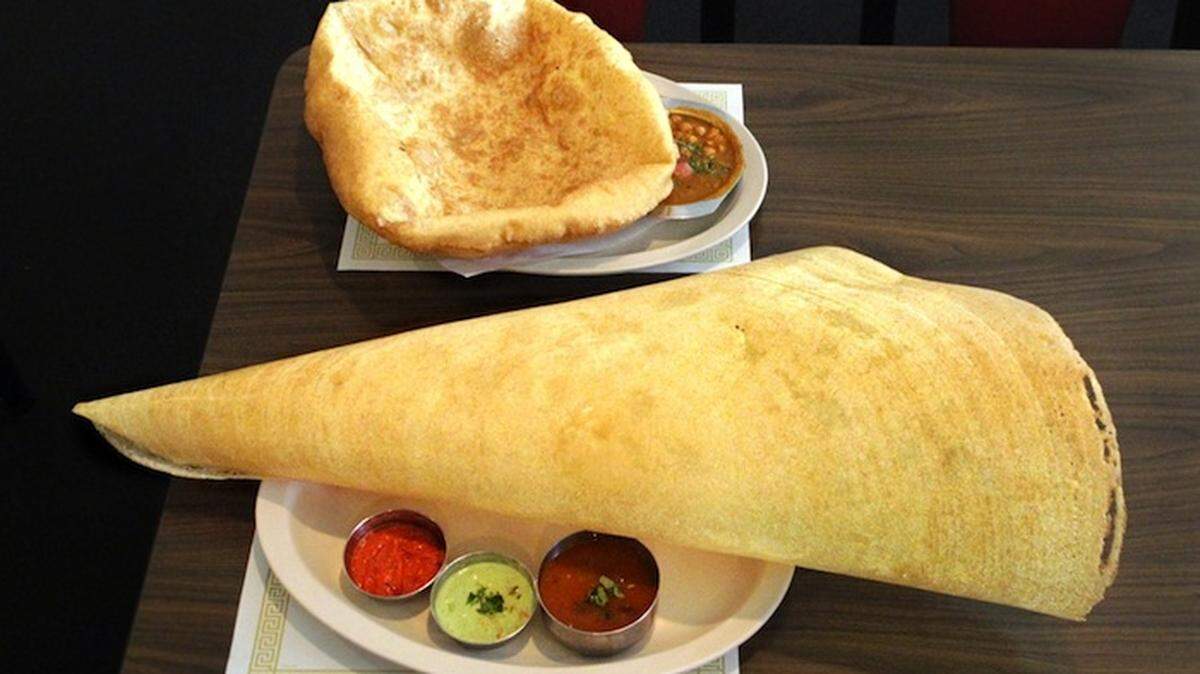 PURE VEGETARIAN: Paper-thin dosai, foreground, and chana bhatura, top.