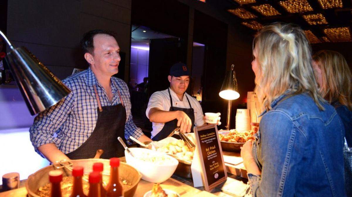 Chef Andrew Carmellini serves guests at Chicken Coupe