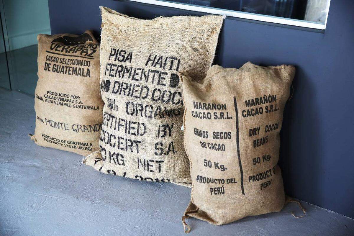 Bags of cocoa beans from Guatemala, Haiti and Peru decorate the entrance of the factory.