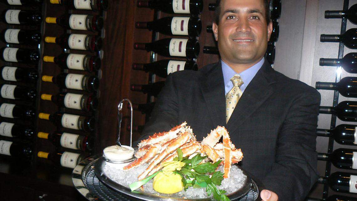 General Manager Scott Gardiner shows off one of their signature crab dishes. Photo: Julie Levin.