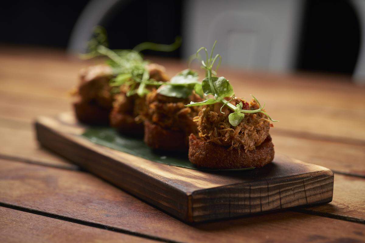 Alcapurrias jueyes are plantain and yucca fritters topped with crab meat at La Placita.
