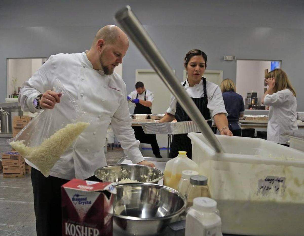 Iron Chef Morimoto’s executive chef at his Napa Valley restaurant, Sean Massey, preps ingredients for their hamburgers at Burger Bash Friday night at the Miami Rescue Mission. Whatever meat is not served at the event will be brought back to the mission, where it will help feed Miami’s homeless. Last year, that amounted to more than 8,000 pounds of ground beef.