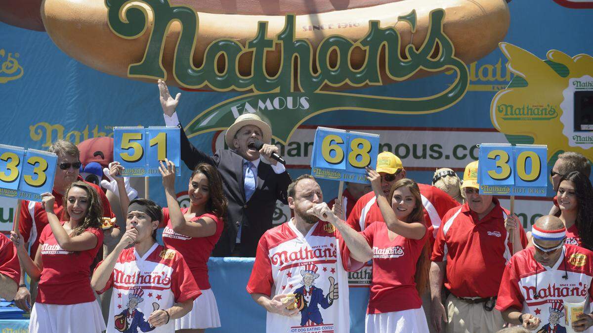 Joey Chestnut, center, pounded 70 hot dogs and buns in 10 minutes at the Nathan's July 4th hot dog contest. But will that prepare him for eating as many croquetas as possible in eight minutes?
