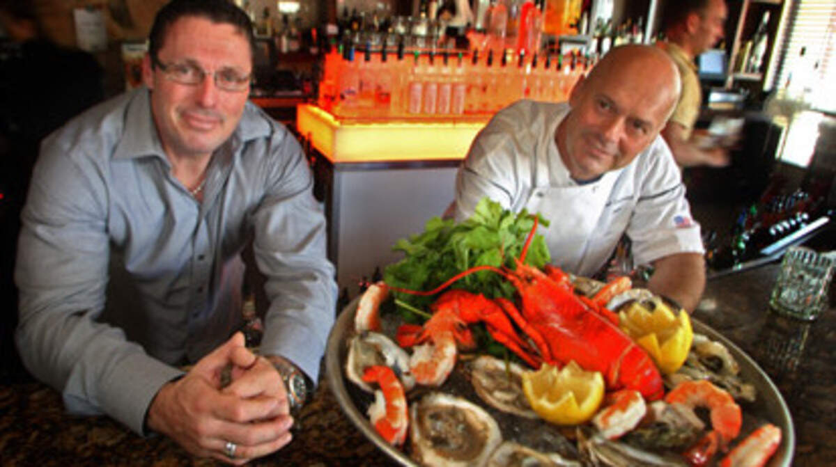General manager and partner, Pierre Berube and chef and owner Laurent Tasic with the "Shellfish Tower" in their restaraunt, Sage, in Hollywood on June 12th, 2009.Photo: Joe Rimkus Jr.