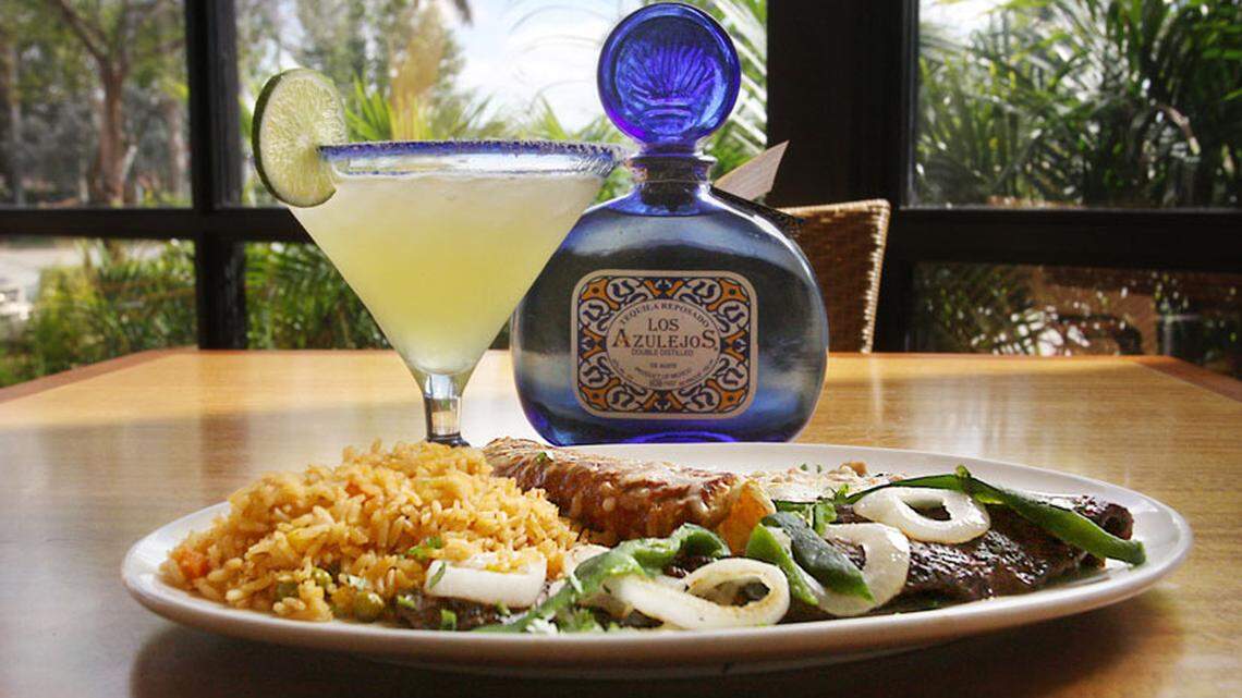 Real tequila mixed with organic juices make up margaritas to go with just about every dish at the Cancun Grill in Miramar. Here, is carne asada topped with roasted onions and poblano peppers and served with a cheese enchilada and rice.