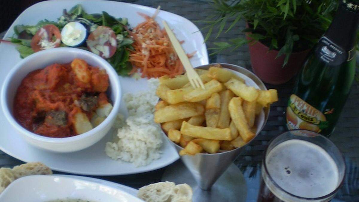 Traditional beef and potato stew in tomato sauce, Fries, sausages and frogs legs in cream sauce at Jean La Frites, Miami Beach.