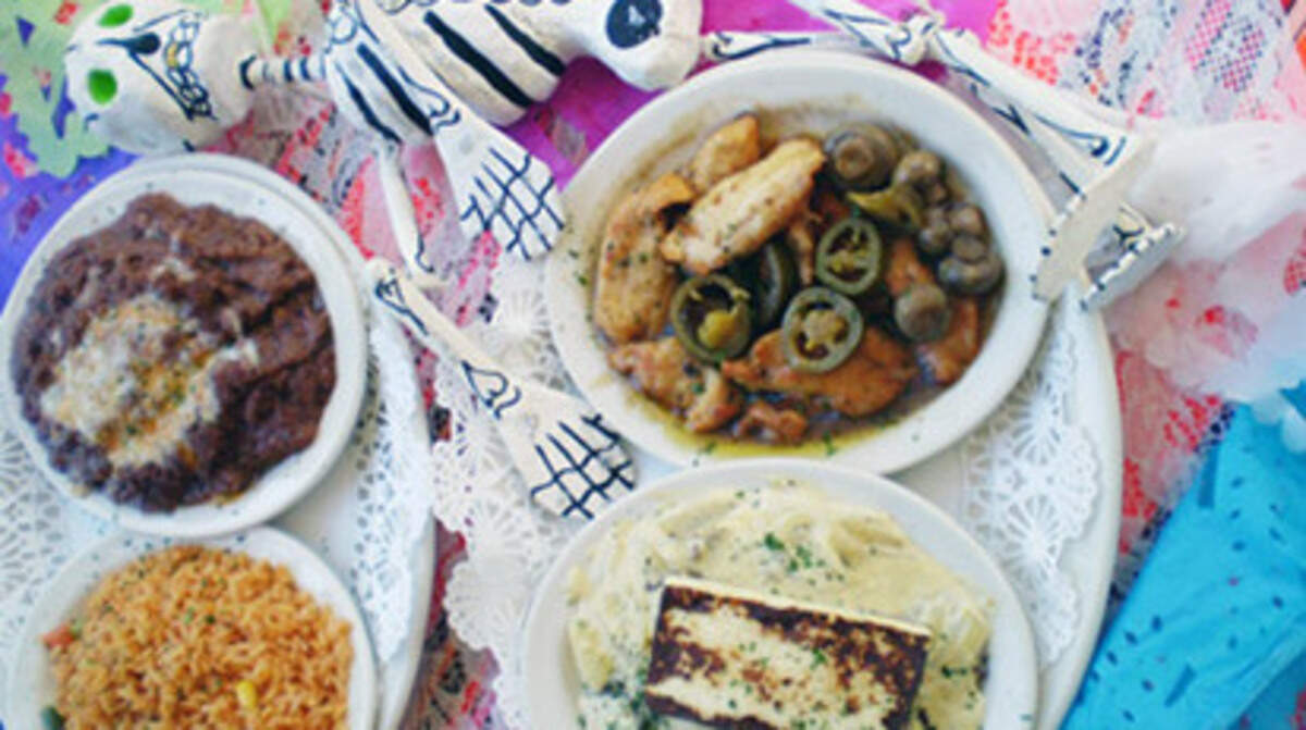 Paquitos Mexican Restaurant in North Miami Beach serves up steak in creamy jalapeno sauce topped with fried cheese and chicken with mushrooms in garlic butter with sides of rice and refried beans year round and for the Day of the Dead celebration November 2nd. Photo: Linda Bladholm.<!-- end forecolor -->