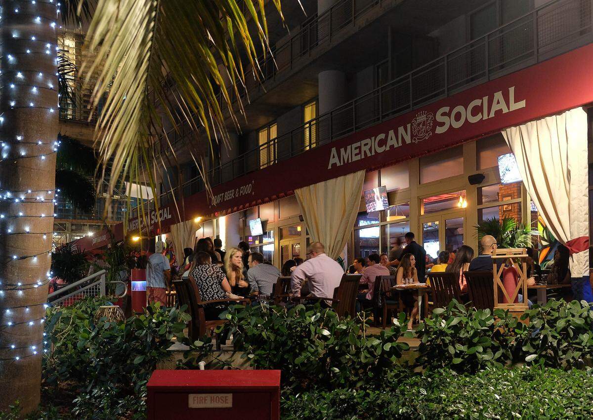 MIAMI, FL - March 7, 2015 - People enjoying themselves at American Social a sports bar and restaurant near Brickell Ave and the Miami River.