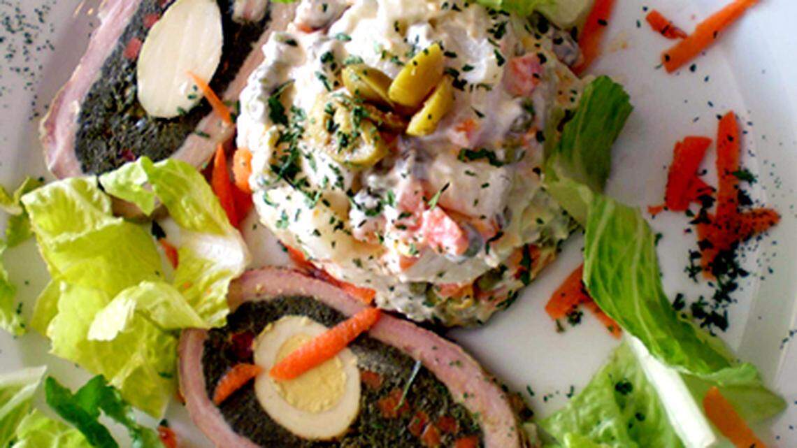 Stuffed veal roll (Matambre "the hunger killer") with Russian potato salad at New San Telmo. Photo: Linda Bladholm.