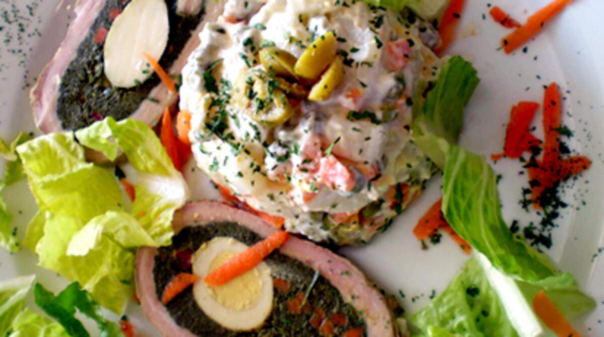 Stuffed veal roll (Matambre "the hunger killer") with Russian potato salad at New San Telmo. Photo: Linda Bladholm.
