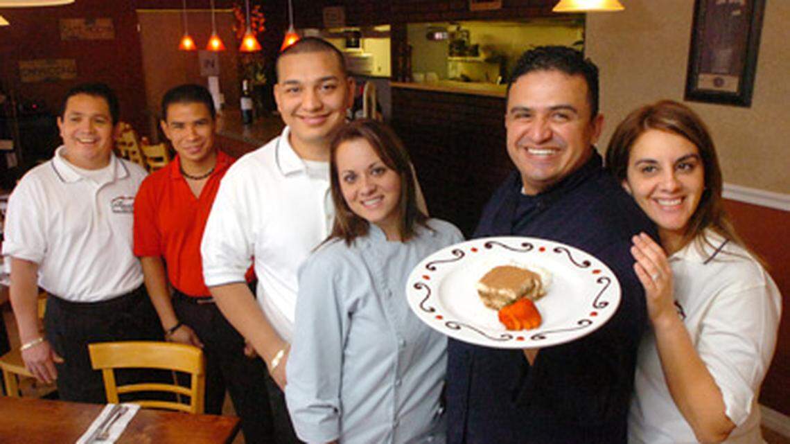 Revales Ristorante, is a family-run restaurant. From the right are Idalmis Reyes, her husband, Marlon Reyes, holding his famous, award-winning Tiramisu, $5.00. Next to him is Yaleisy Espinales, sister to Idalmis, and her husband, David Espinales, and workers, Eddie Cerrud, and Jesus Argueta,