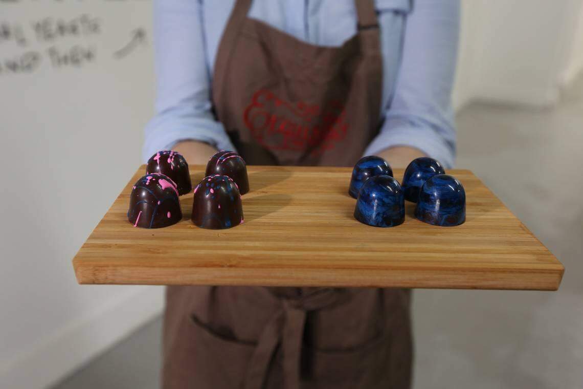 Exquisito Chocolates is opening Miami's first chocolate factory in Little Havana. Owner Carolina Quijano displays two different truffles, the Miami Vice (L) and the Guatemalan rum.