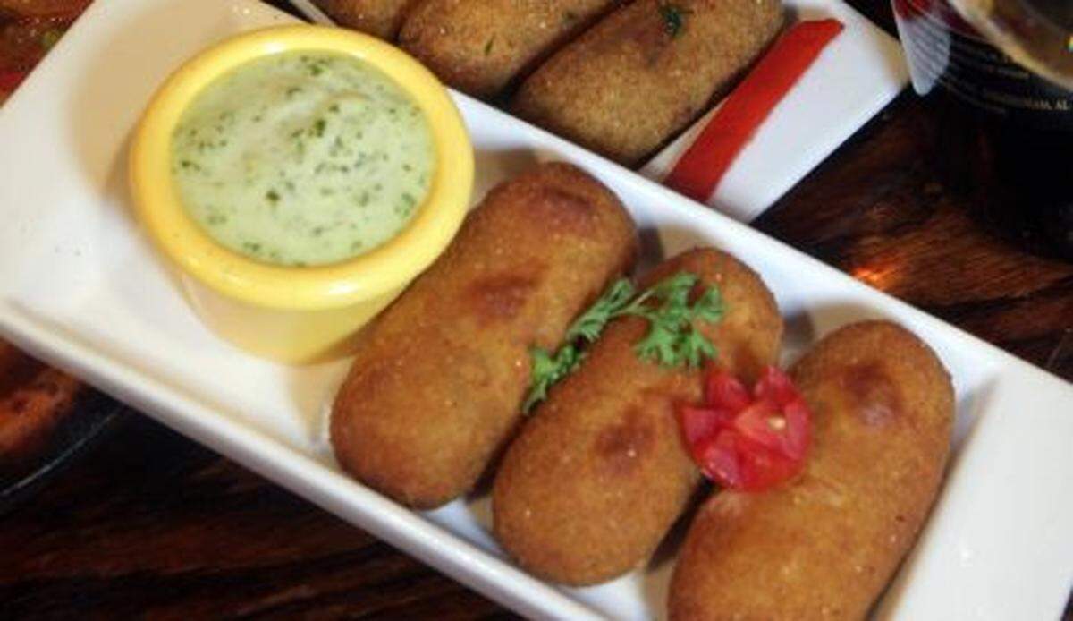 Traditional croquetas, like these served at El Carajo restaurant in Miami. are usually served with a bechamel sauce, But people are more than happy to eat them without sauce.