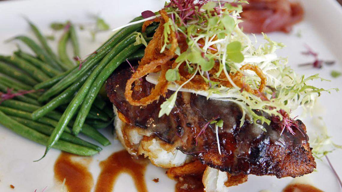 Chef Michael Bennett and owner Steve Hudson. Caribbean Spiced Wood-Grilled Salmon, $19.00. Photo: Charlotte Southern.