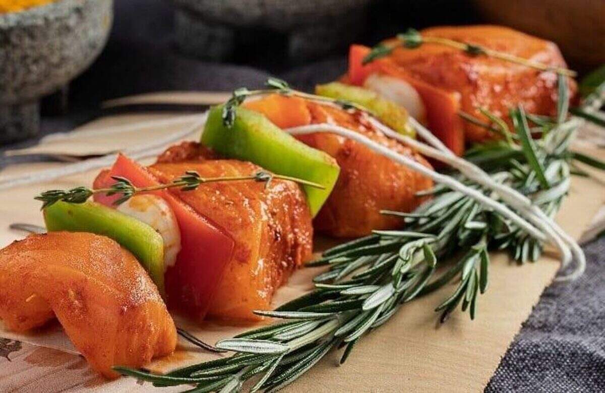Salmon and vegetables skewered on rosemary sprigs at Krudo Fish Market