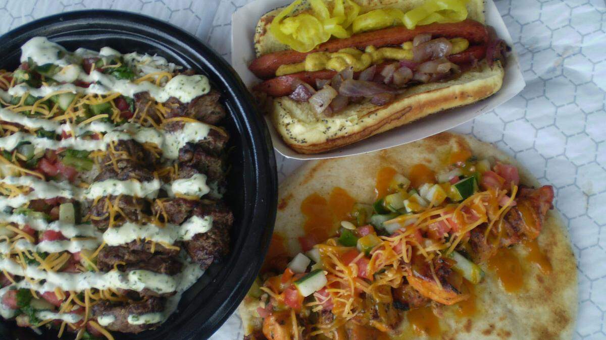 Beef kebab on a rice bowl and chicken kebab off the skewer on pita with a Chicago-style hot dog at Pincho Factory in Westchester.