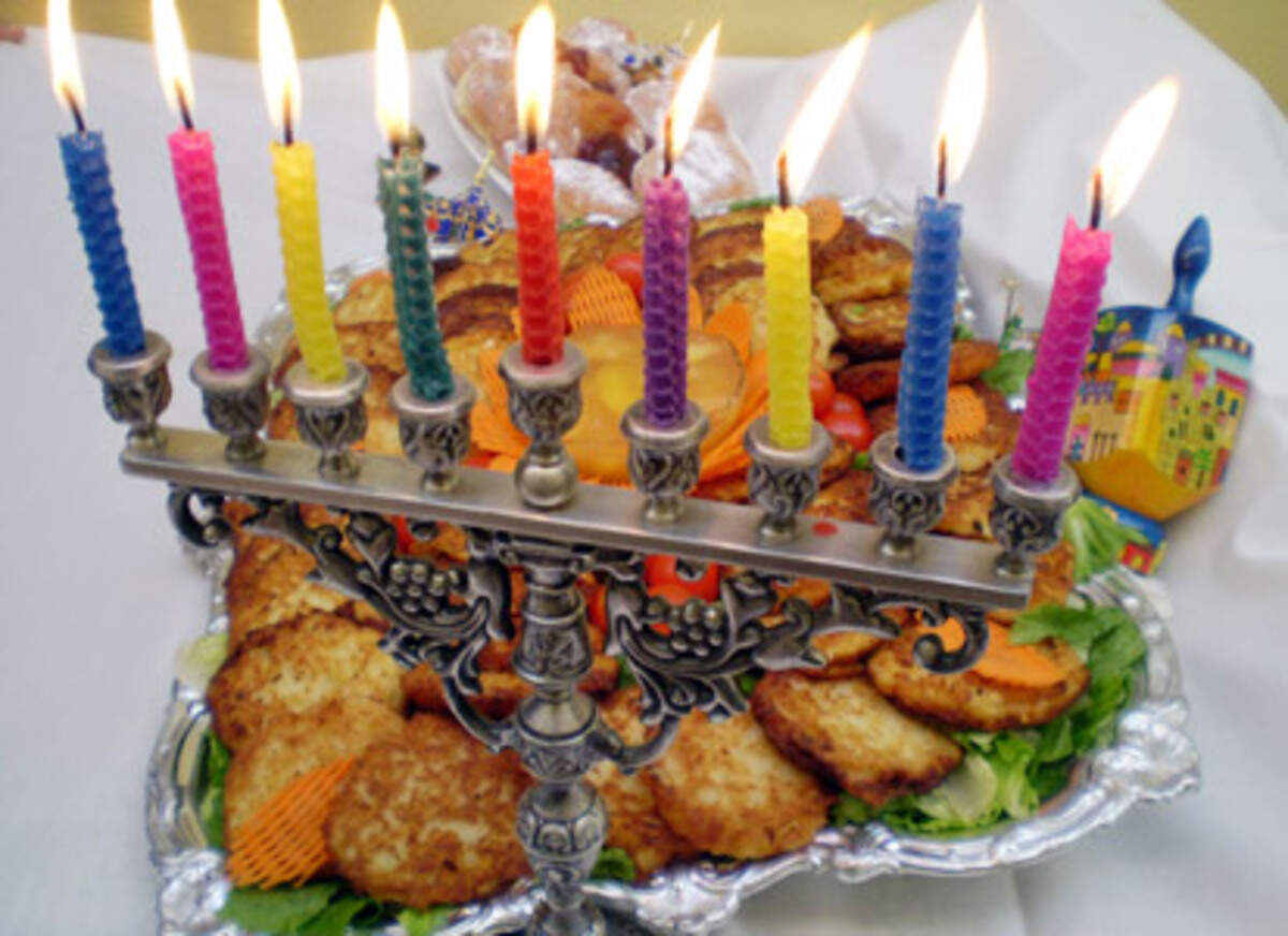 Lit menorah with latkes (potato pancakes) and jelly doughnuts at the Jewish Museum of Florida, Miami Beach. They will be served through December 29th in Bessie's Bistro, the museum cafe, to celebrate Hanukkah, the festival of light. 