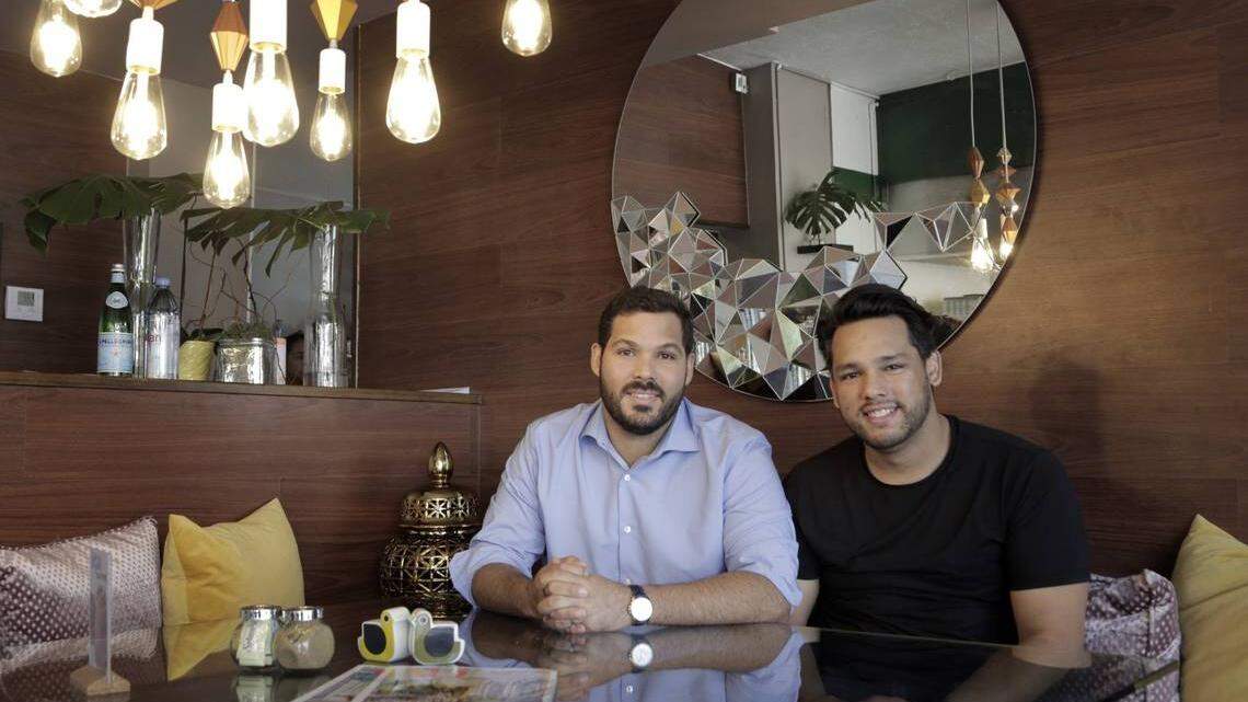 Ivan Nieves, left, and his husband, David Flores, moved to Miami from Puerto Rico after Hurricane Maria destroyed their home in the Condado suburb of San Juan. They opened a second version of their restaurant, La Social, in Miami, at 7601 Biscayne Blvd., while popular demand helped them reopen their original restaurant on the island.