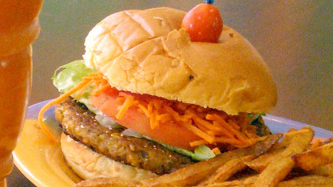  Carrot juice and veggie burger with fries at Gourmet Carrot Natural Food Restaurant.