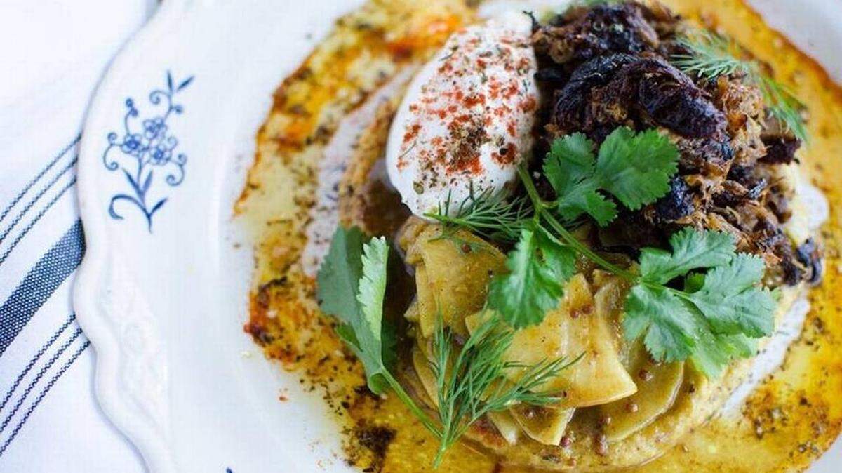 Braised lamb with house pickles, hummus and labneh.