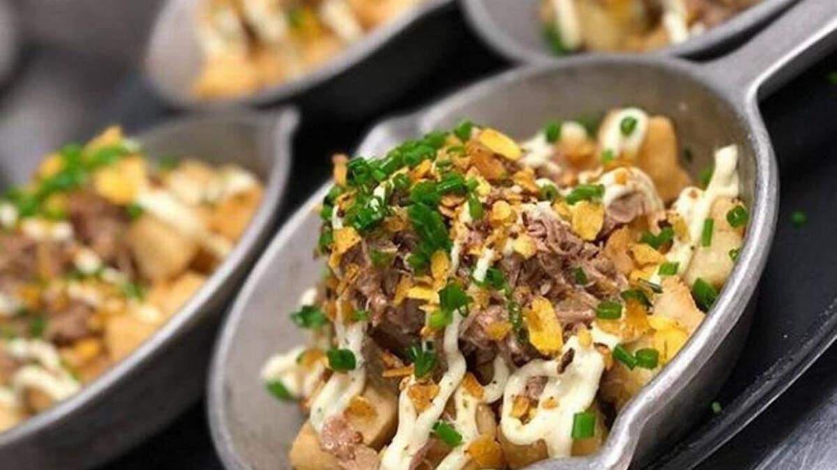 The Cuban Tots at Amelia 1931 can be made of yuca, malanga or sweet potato. These malanga tots are topped with vaca frita shredded beef and aji amarillo pepper sauce.