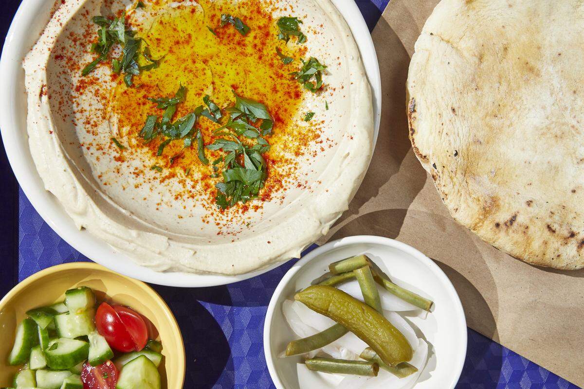 Hummus at Dizengoff is served with a salad and in-house baked pita bread.